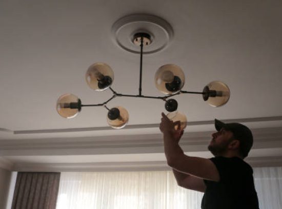 Young man wearing chandelier for decoration