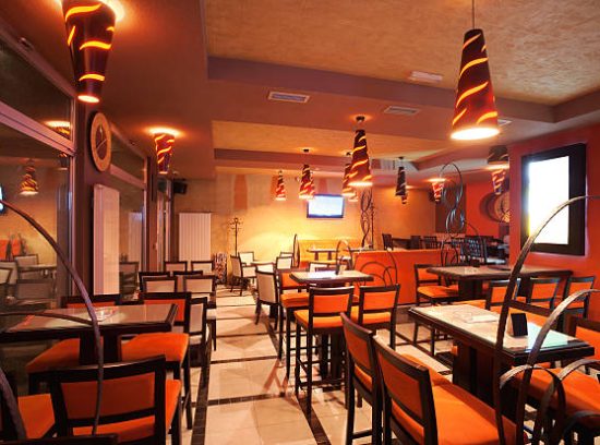 Interior of a restaurant, modern design in few colors, orange and brown.