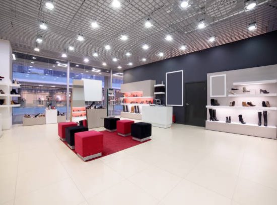 bright and fashionable interior of shoe store in modern mall
