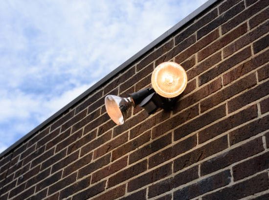 Flood light on external brick wall daytime look up