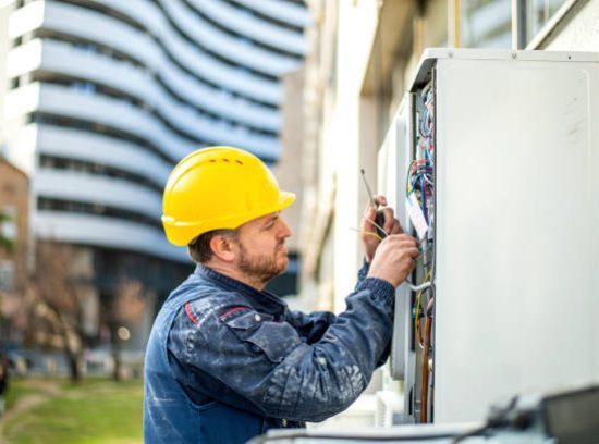 Air conditioner technician services outdoor AC unit and the Gas Generator